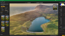 Aerial landscape showing a bright blue lake surrounded by green valleys and brown mountains under golden hour light.