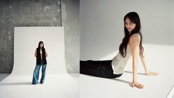 Woman posing on white seamless backdrop with studio lighting, shown both in foreground and as reflection in background setup.