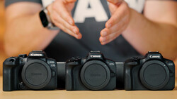 Three Canon EOS DSLR camera bodies arranged in a row, shown from the front with a person holding an 'A' card above them.