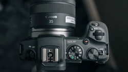 Canon EOS RP camera with Canon 35mm lens mounted, viewed from above showing top plate controls and hot shoe.