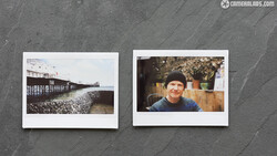 Two instant film photographs displayed side by side on a textured gray surface.