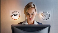 Woman at computer workstation with illuminated OPT and OUT button graphics floating beside her head.