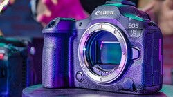 Canon EOS R5 mirrorless camera body displayed against colorful purple and cyan lighting.