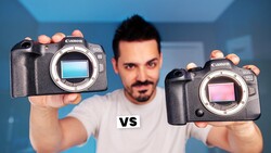 Photographer holding two Canon mirrorless cameras with different colored sensor displays, separated by "vs" text.