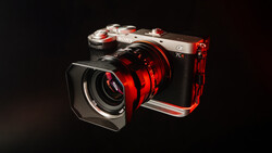 Red and silver mirrorless camera with matching red lens and L-bracket cage against dark background.