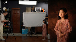 Studio portrait setup with subject in coral textured garment positioned on right, professional lighting rig with diffusion panel and key light visible on left side.