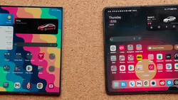 Two smartphones displaying colorful home screens with app icons and widgets on a cork surface.