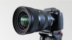Wide-angle prime lens mounted on a mirrorless camera body against a neutral background.