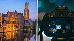 Medieval European canal city at dusk reflected in still water, with a tall bell tower illuminated against twilight sky.
