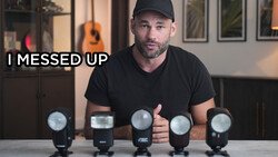 Photographer with five camera flash units arranged in a row on a table, appearing to address a mistake.