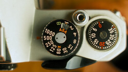 Vintage camera exposure meter dials with ASA settings and aperture values displayed.