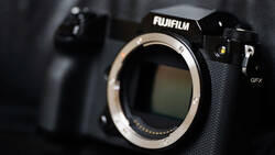 Fujifilm GFX camera body with lens mount exposed, shot against dark background with shallow depth of field.