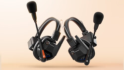 Pair of black gaming headsets with flip-up microphones positioned side by side against a beige background.