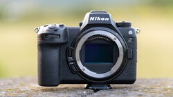 Nikon Z mirrorless camera body shown from front with lens mount exposed against blurred background.