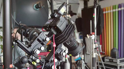 Professional cinema camera mounted on a rig with multiple lenses and accessories in a production studio.
