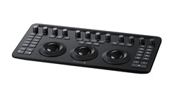 Black DJ controller with three large jog wheels and multiple faders arranged across the top surface.