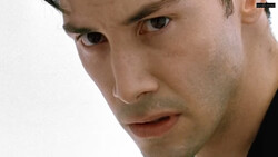 Close-up portrait of a man with a serious expression against a white background.