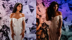 Woman in off-shoulder white lace wedding dress photographed against abstract artistic backdrop with contrasting lighting.