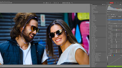 Screenshot of photo editing software showing a portrait of two people wearing sunglasses outdoors.