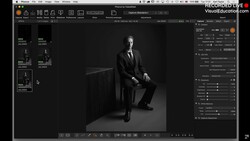 Screenshot of photo editing software displaying a black and white portrait of a man in business attire seated against a dark background.
