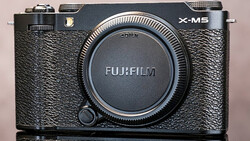 Fujifilm X-M5 mirrorless camera body with black textured grip and dark lens cap.