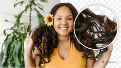Woman in yellow top with curled dark hair holding a sunflower, smiling at camera with plants in background.