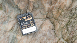 T-Create Expert 64GB SD card displaying 300MB/s write speed specifications on textured stone surface.