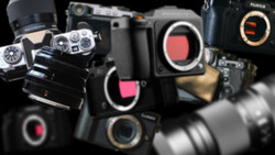 Collection of professional cinema and mirrorless cameras with sensor ports visible, arranged against a dark background.