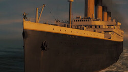 Large ocean liner with yellow superstructure and dark hull positioned at a dock during golden hour.