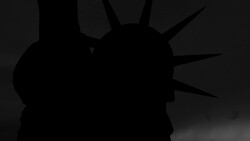 Silhouette of a spiky-haired head in profile against a dark background with radiating light rays.
