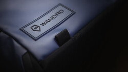 Close-up of a Wandpro branded label on camera equipment with dramatic side lighting.