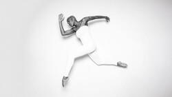 Overhead view of a person in white clothing performing a dynamic jumping pose against a white background.