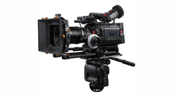 Professional cinema camera with matte box and follow focus mounted on fluid head tripod.