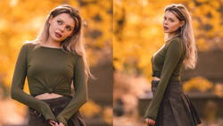 Woman in olive long-sleeve crop top and dark skirt posed against warm golden autumn foliage background.