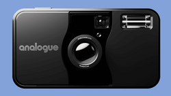 Analogue brand 35mm film camera with black body, fixed lens, and pop-up flash against blue background.