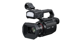 Panasonic 4K professional camcorder with flip-out monitor and shoulder-mounted viewfinder.