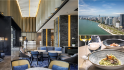 Luxury hotel lobby with modern design featuring gold ceiling details, blue seating, and marble accents.