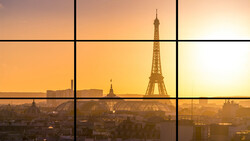 Eiffel Tower silhouetted against golden sunrise with Paris cityscape and grid window frame overlay.