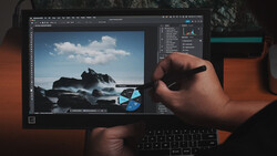 Screenshot of photo editing software displaying a coastal rock formation with waves under blue sky.