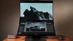 Laptop displaying mountain landscape photo with editing software panels open on secondary monitor.