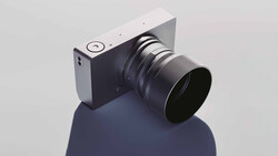 Mirrorless camera with interchangeable lens mounted on a reflective blue-gray sphere.
