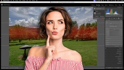 Woman in red and white striped off-shoulder top posing in front of a landscape with green grass and red flowering trees.