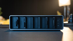 Blue-rimmed modular charging dock with eight vertical slots containing dark charging modules.