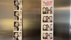 Two photo booth strips displayed on a refrigerator, showing couples in candid moments.
