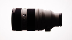 Sony G-series telephoto lens with black barrel and white accent ring on neutral background.