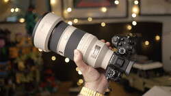 Mirrorless camera with large telephoto lens held up to display the setup during holiday season.