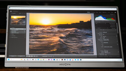 Screenshot of photo editing software displaying a golden-hour beach sunset image with waves and warm sky tones.