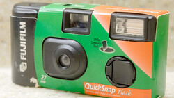 Fujifilm QuickSnap Flash disposable 35mm camera with green and orange packaging, featuring a flash unit and viewfinder window.
