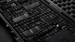 Multiple portable radios arranged in a protective foam-lined carrying case.