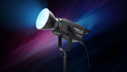 Professional LED spotlight with white beam output against a dark background with blue and magenta light rays.